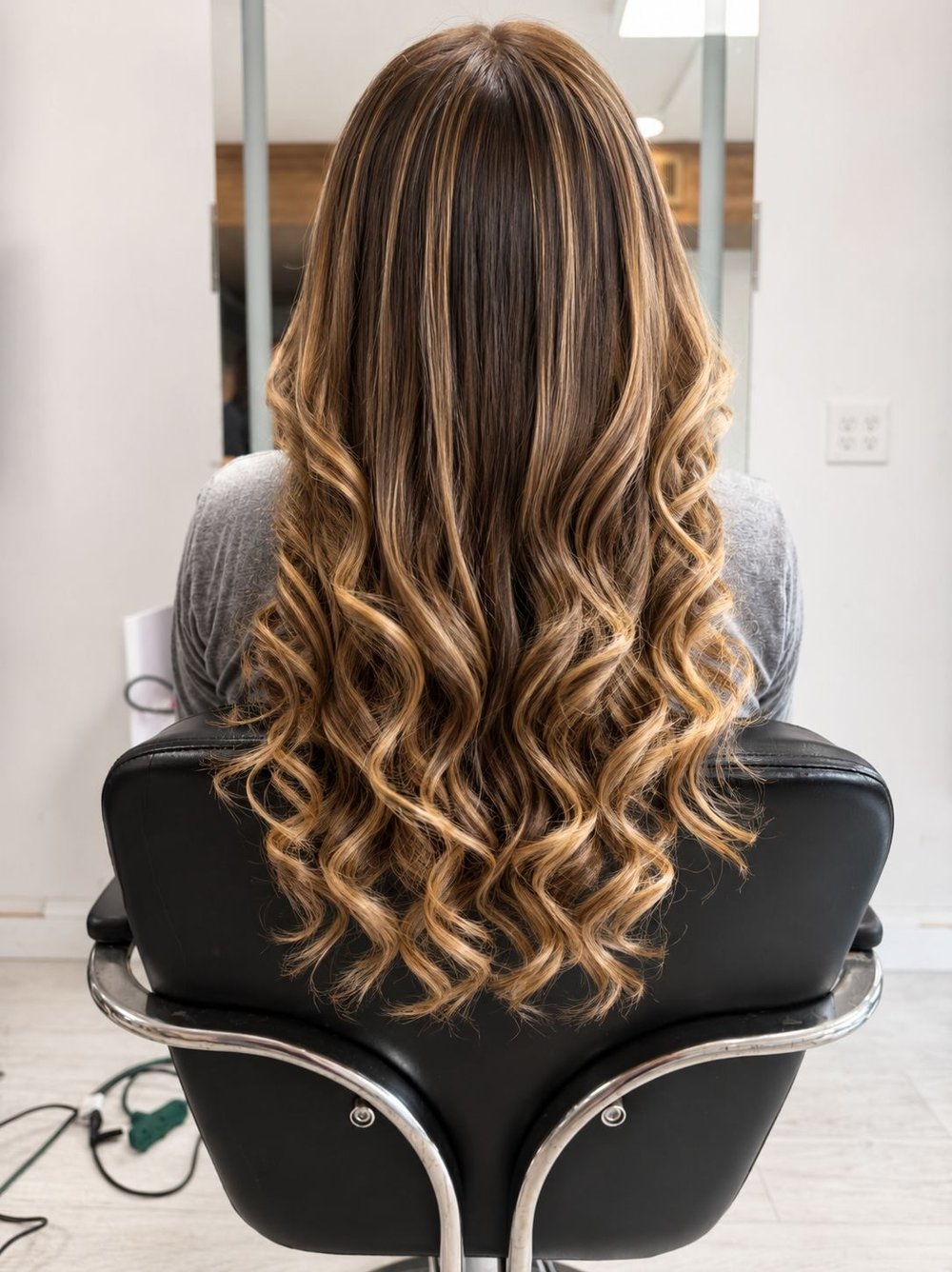 Long hair with caramel balayage, curled to the ends